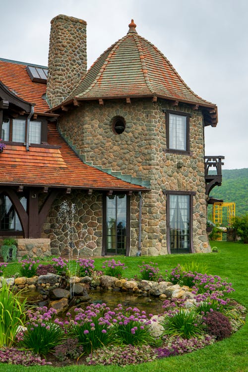Free Stone House With Green Grass Lawn Stock Photo