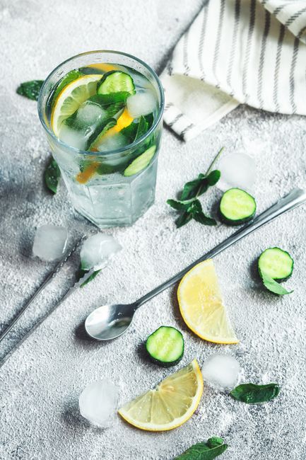 A refreshing cucumber, lemon, and mint drink with ice, perfect for summer hydration.