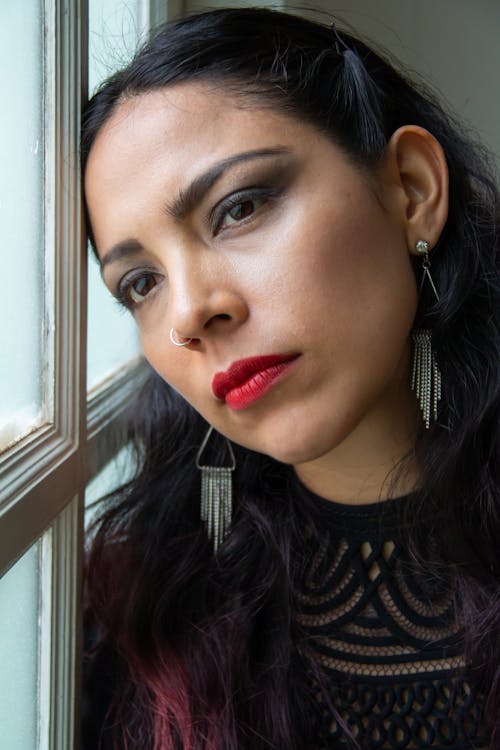 Woman in Black Top Leaning on the Window