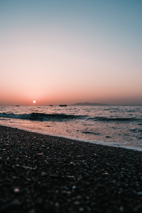 Sea Waves Crashing the Shore at Sunset