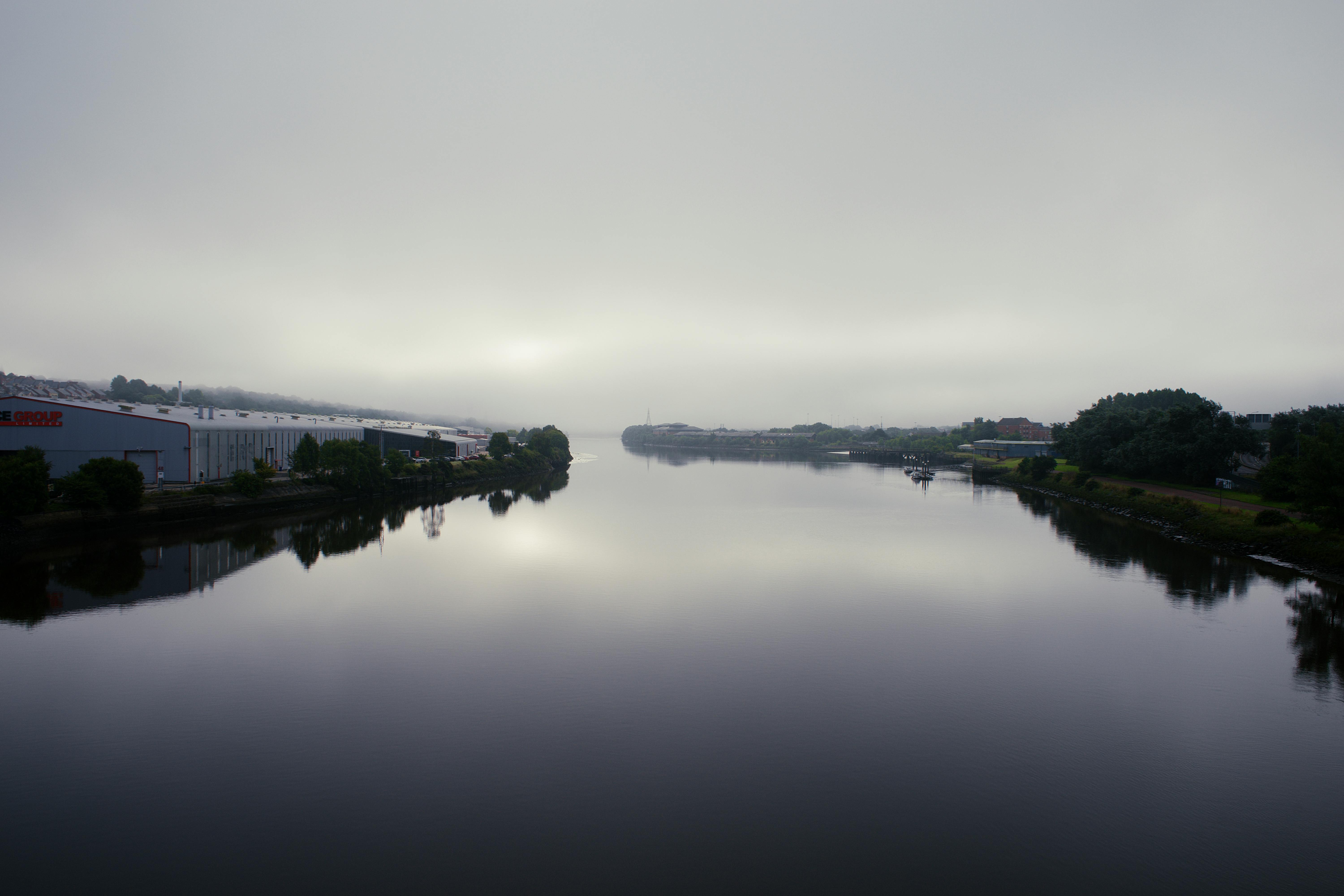 Serene foggy scene of the River Tyne in Newcastle upon Tyne, England, with overcast skies.
