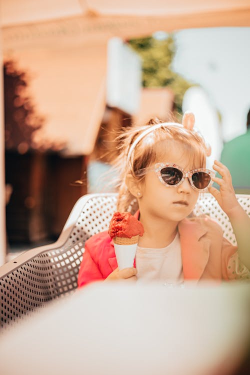 A Kid Sitting on the Armchair