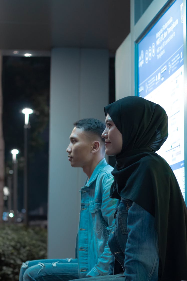 Couple Sitting At Stop At Night