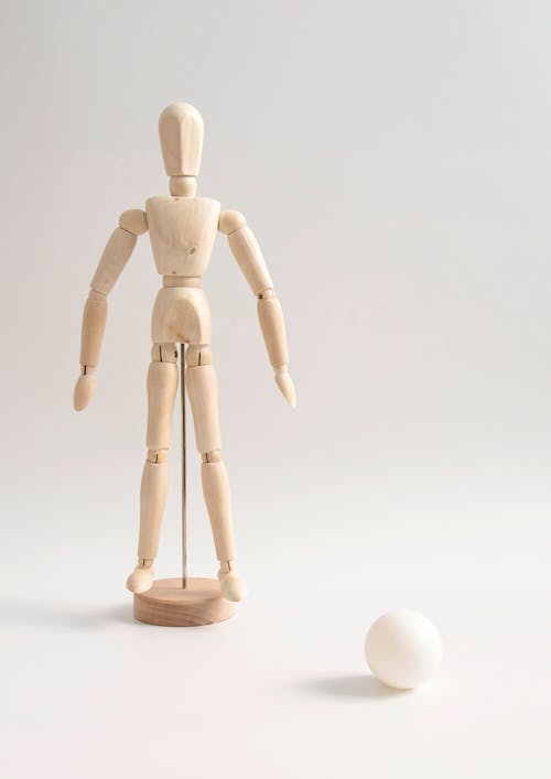 Free Close-Up Shot of a Wooden Human Figurine Stock Photo