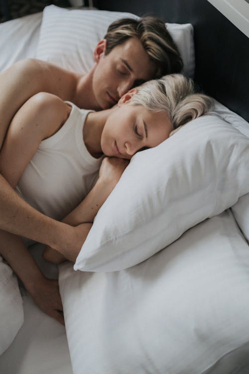 Free A Couple Lying on the Bed Stock Photo