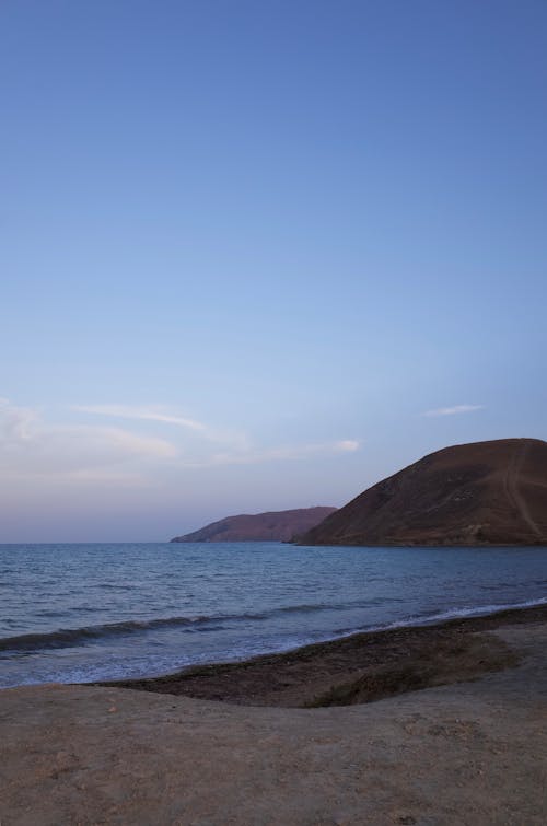 Brown Mountain Beside Body of Water