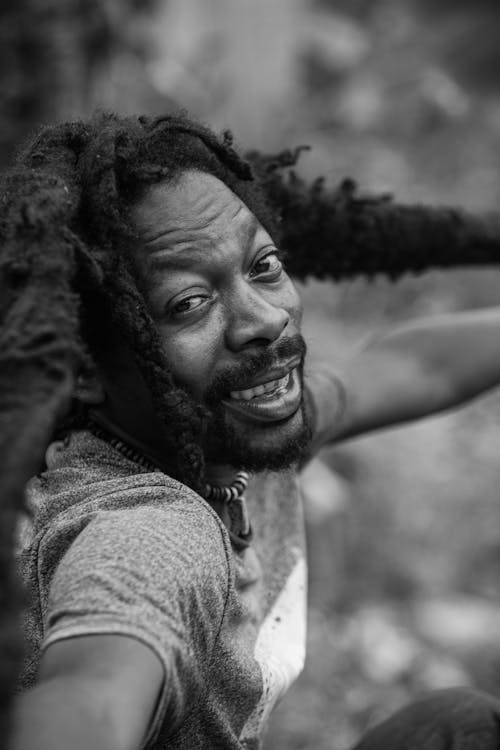 Grayscale Photo of A Man Smiling