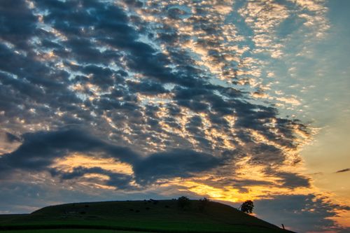 Free Stunning sunset over rolling hills in rural Minnesota with a dramatic sky. Stock Photo