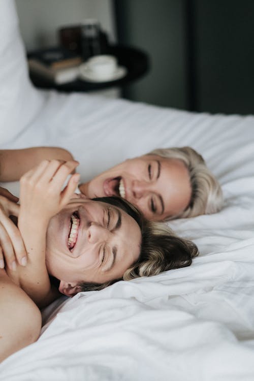 Free A Couple Lying on the Bed Stock Photo