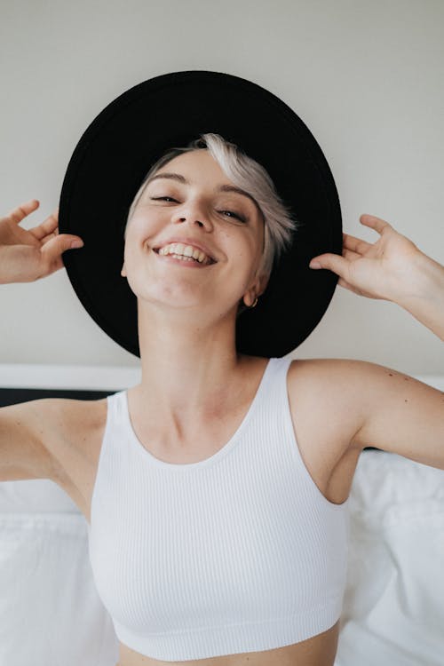 Free Woman in White Tank Top Smiling Stock Photo