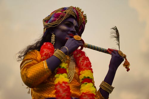 Indian Woman in Krishna Costume a Flute 
