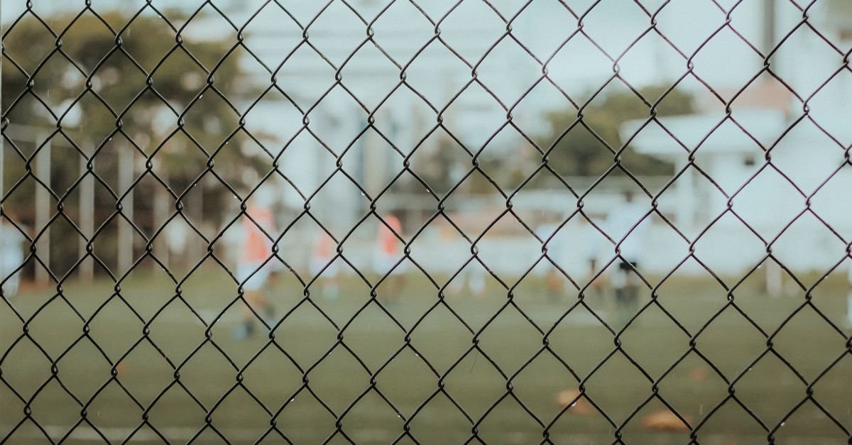 Close-up of a football goal net on a well-maintained pitch in Ho, Ghana