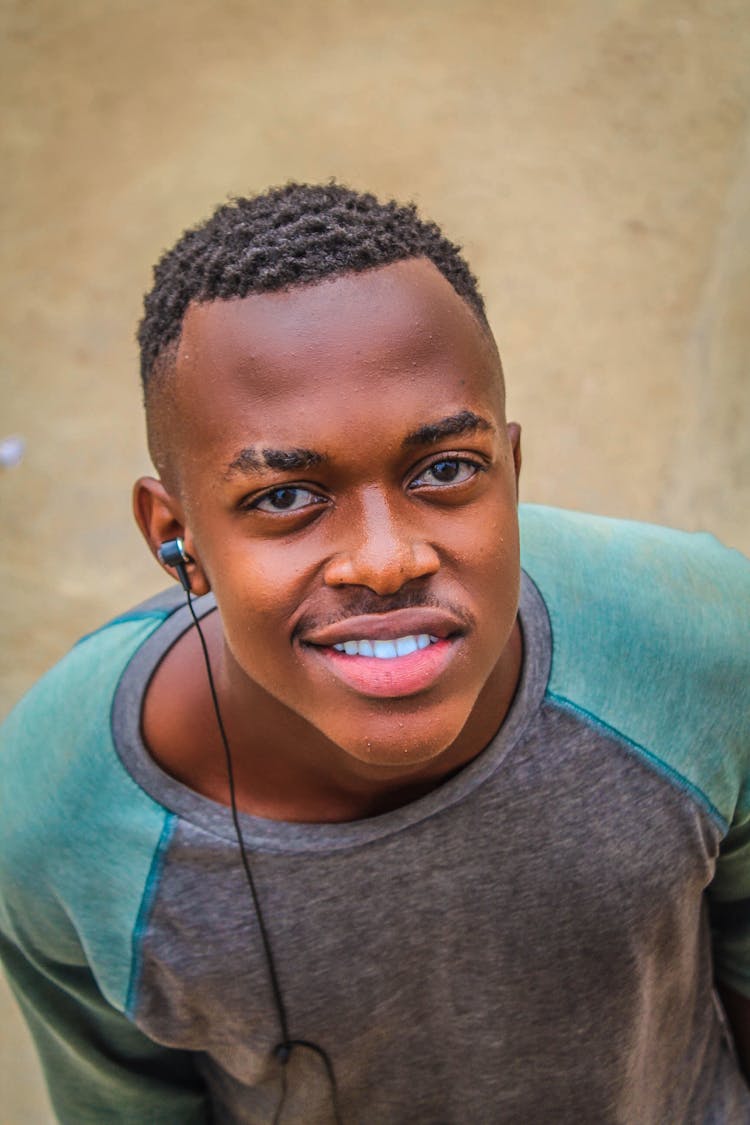 Young Man With A Ear Bud Headphone 