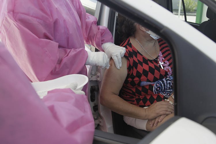 A Woman Getting A Vaccine Shot In Her Arm