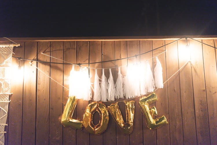 Lights And Letter Balloons Hanging On Wall