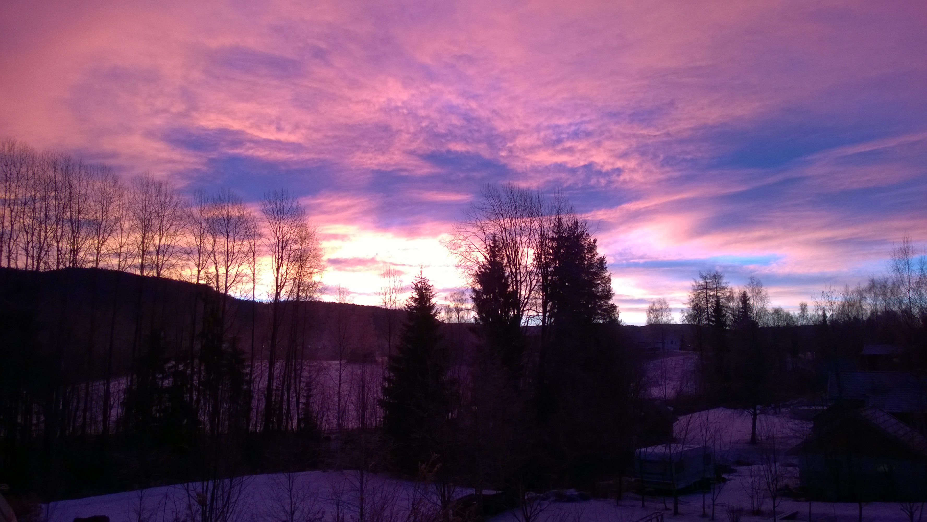 Breathtaking winter sunset with vibrant skies over snowy landscape in Kongsberg, Norway.