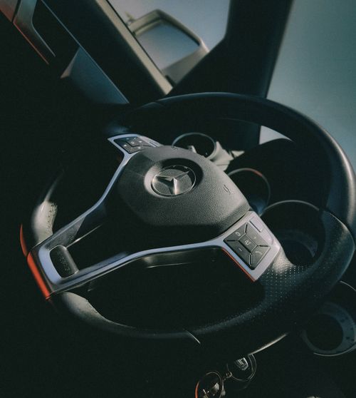 Free Detailed look at a car steering wheel with natural light illumination. Stock Photo