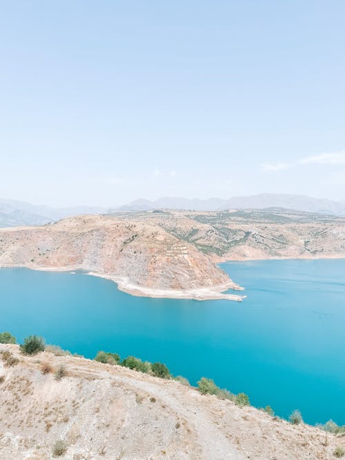 Clear Sky over Hills on Sea Shore