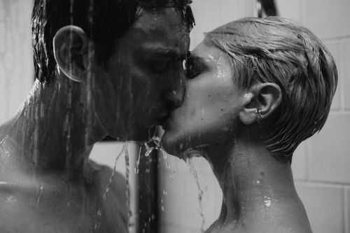 Free Intimate grayscale image capturing a couple kissing passionately in a shower. Stock Photo