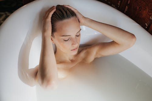 Woman Lying on Bathtub