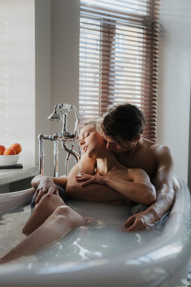 A Couple Bathing Together In A Bathtub