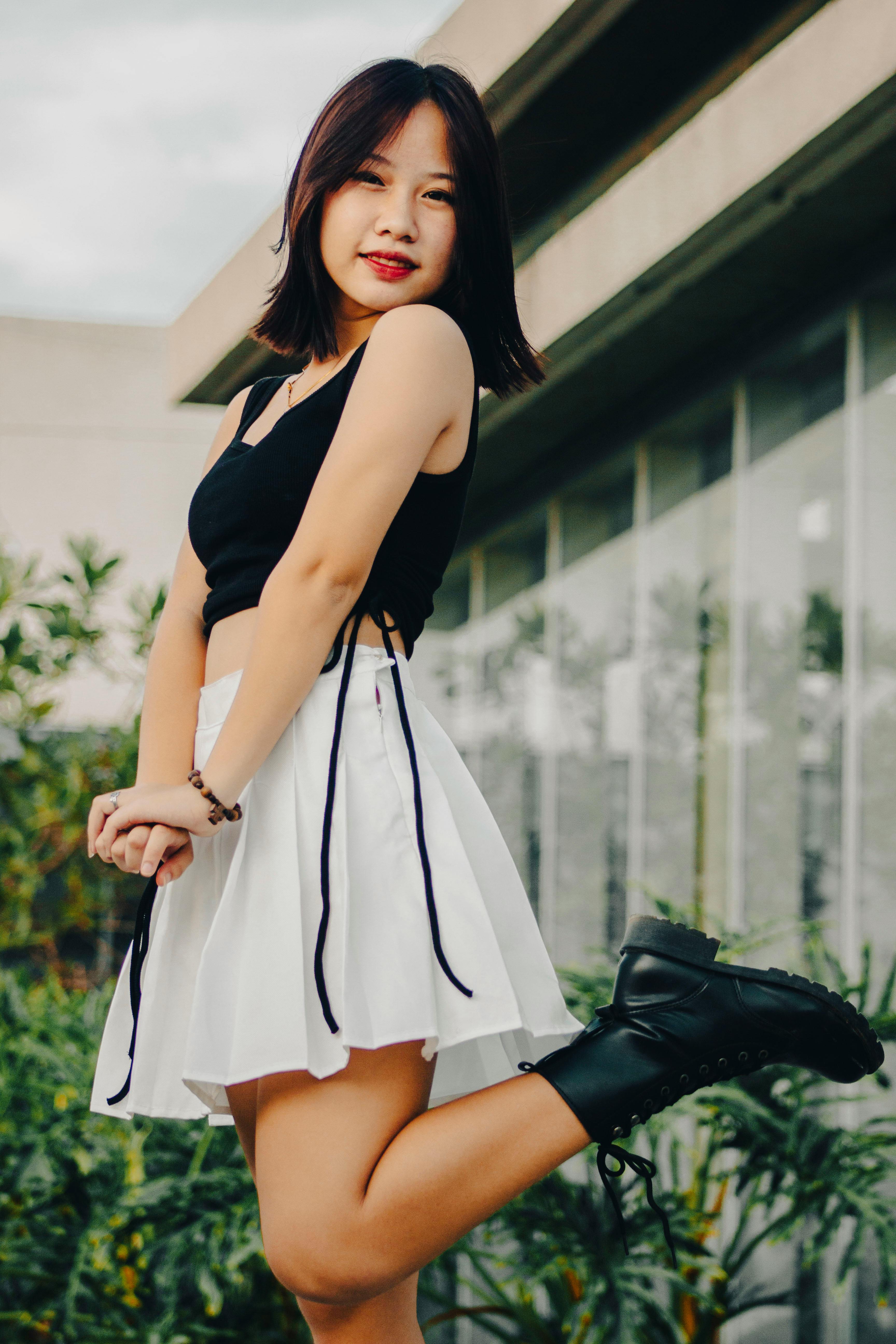 A Girl in Black Crop Top and White Skirt Posing Free Stock Photo