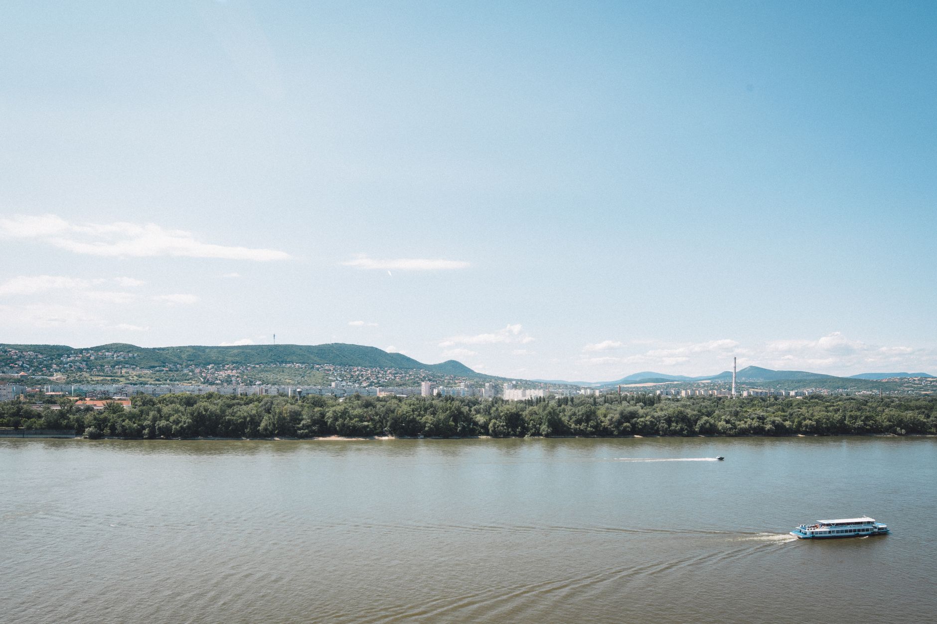 A serene view of the Danube River with a distant panorama of Budapest, Hungary.