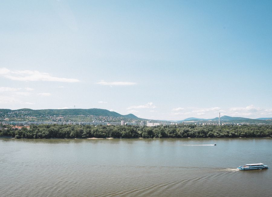 A serene view of the Danube River with a distant panorama of Budapest, Hungary.