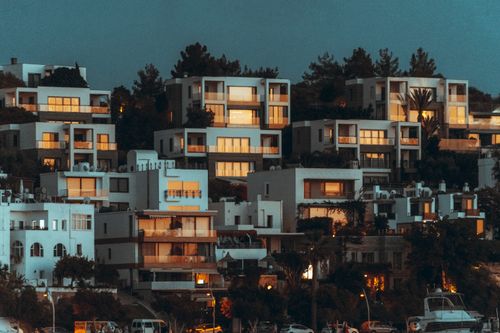 Free Contemporary hillside houses in Bodrum, Turkey, illuminated at twilight, showcasing modern architecture. Stock Photo