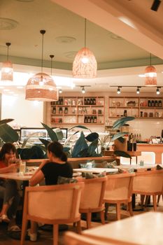 Warm and inviting café interior with wooden furniture and pendant lighting.