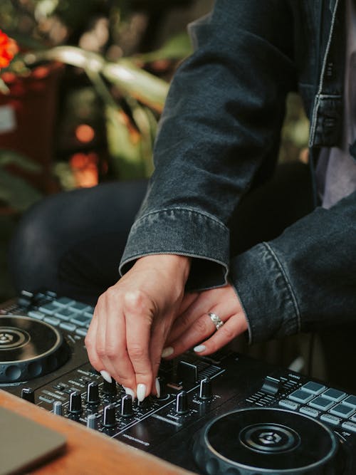 Free A Person Controlling an Audio Mixer Equipment Stock Photo