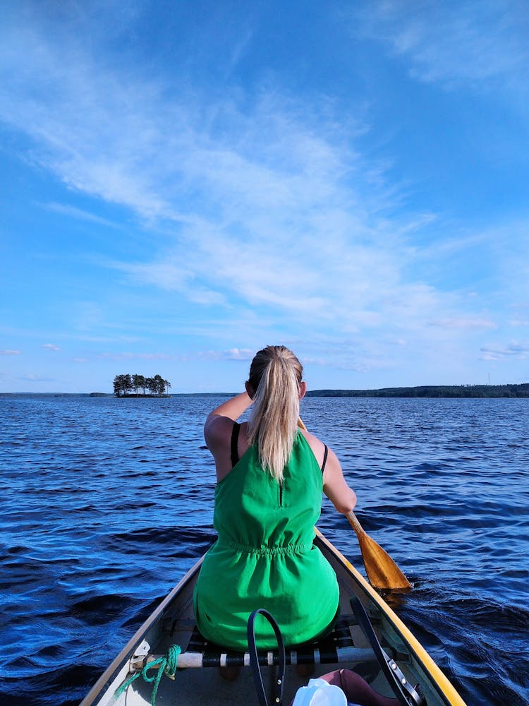 Woman Sitting In Canoe Rowing