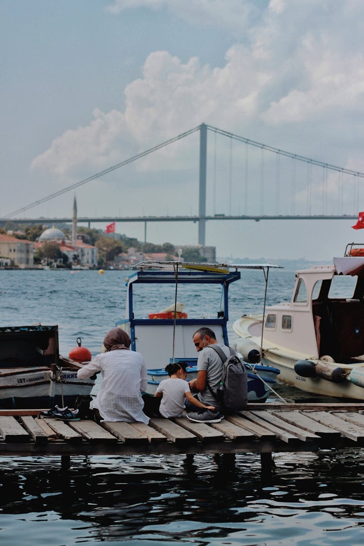 Family Sitting On Pier In Istanbul