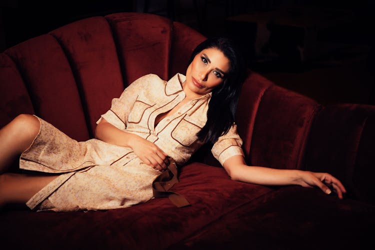 Brunette Woman Lying On Sofa