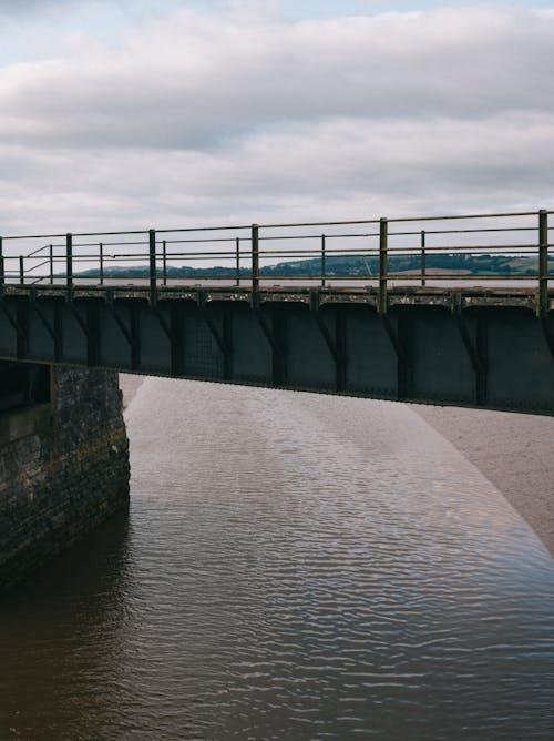 A Gray Bridge Over Body of Water