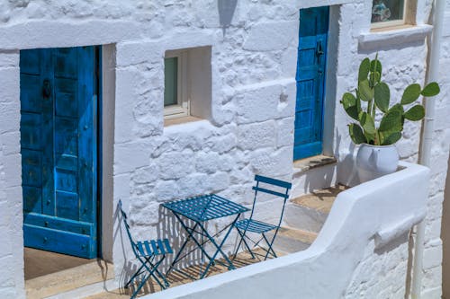 Blue Wooden Door on White Concrete Wall