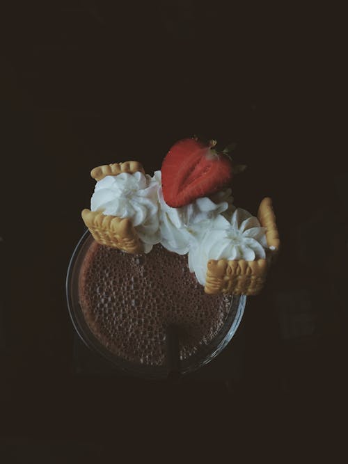 Whipped Cream with Biscuits and Strawberry on Glass with Chocolate Drink