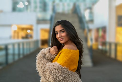Woman in Yellow Off Shoulder Shirt and Gray Fur Coat