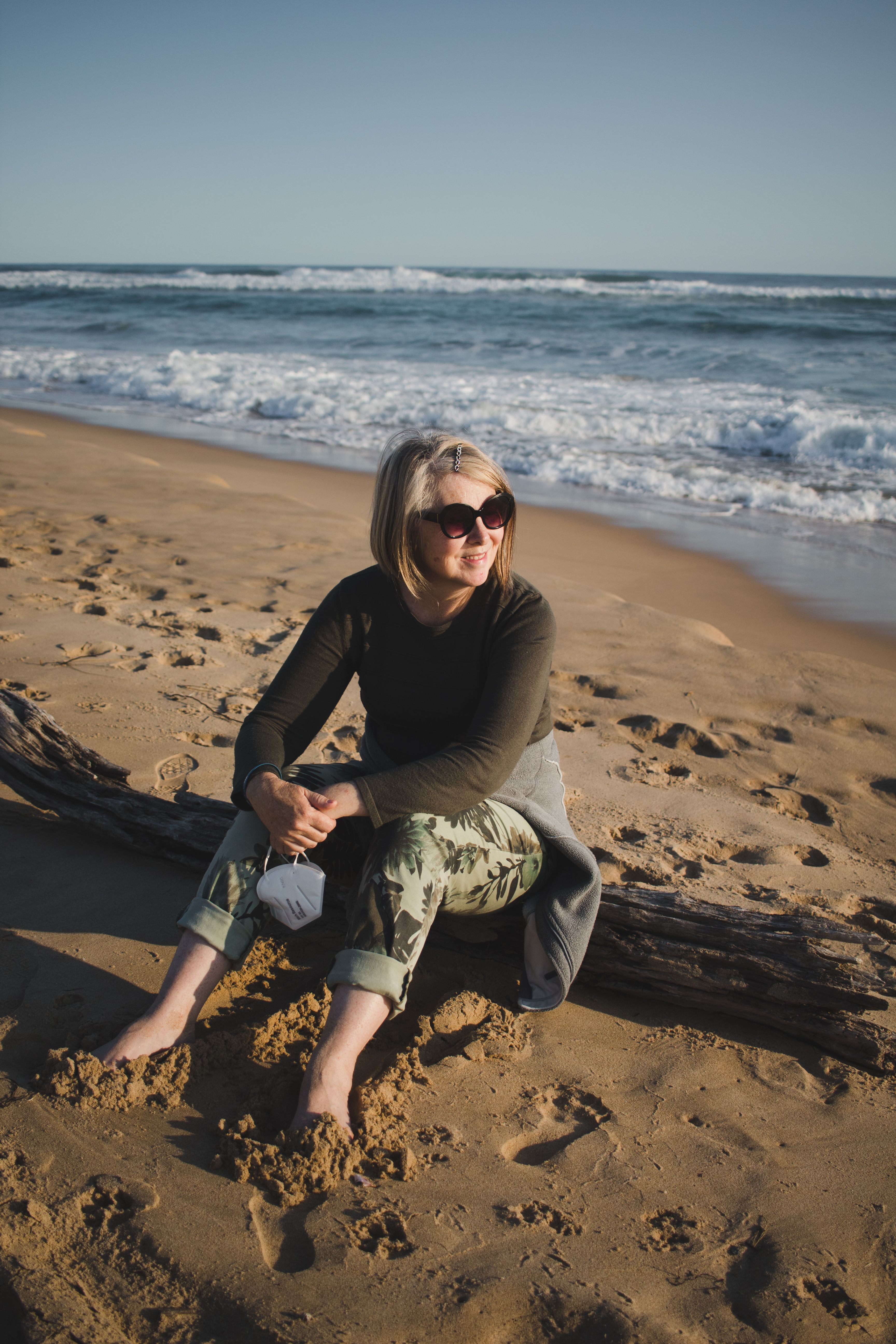 Woman in Bikini Sitting on Beach Shore · Free Stock Photo