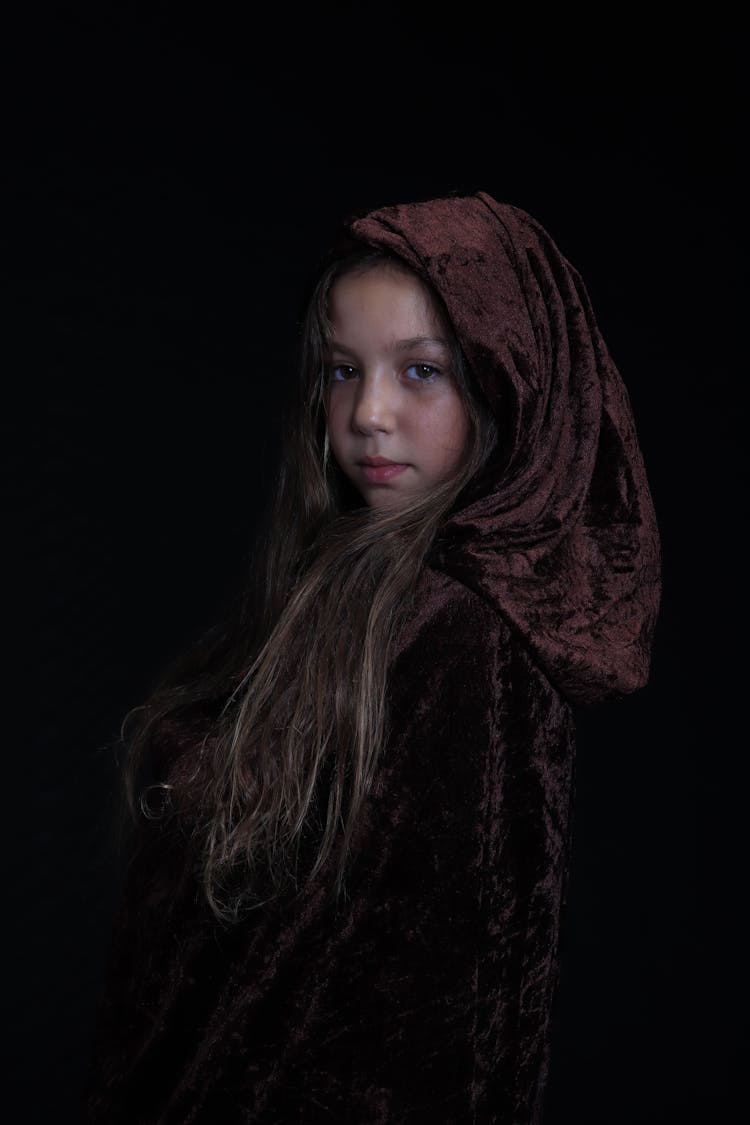 A Girl Wearing A Hooded Cloak