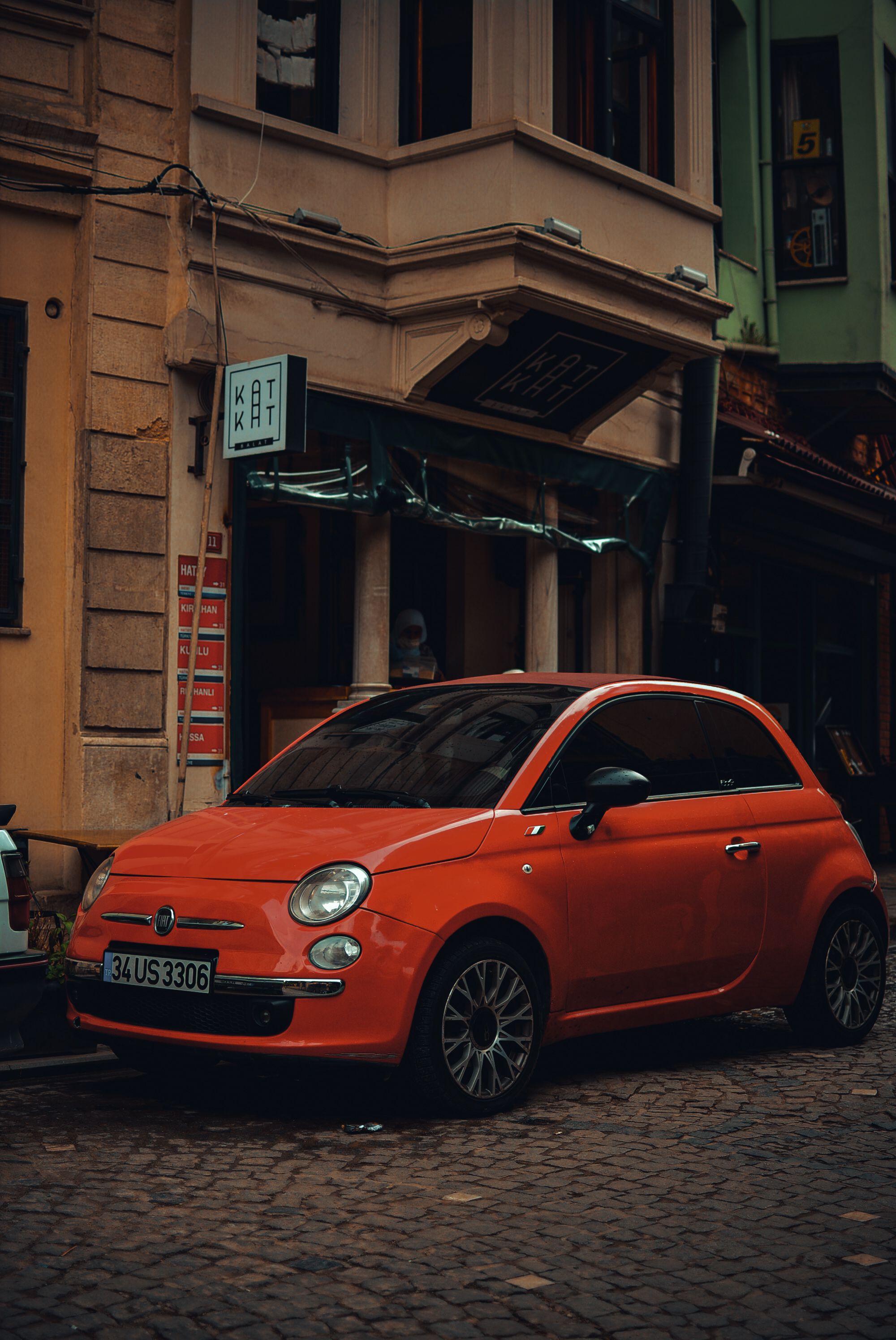 Red Car Parked in Front of a Building · Free Stock Photo