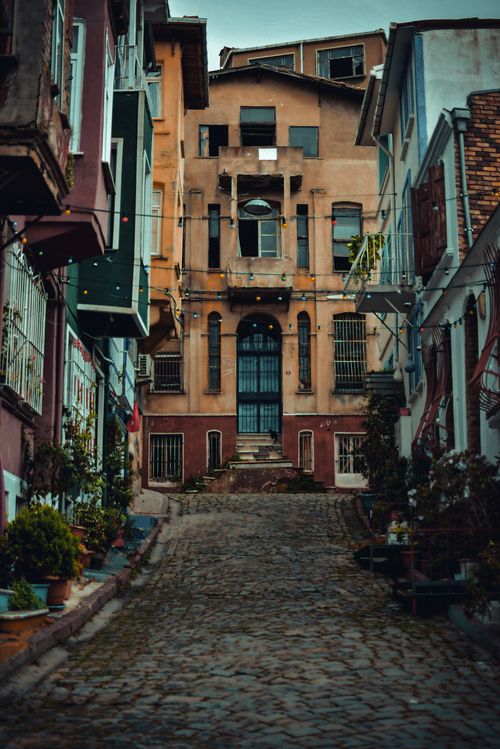 Free A narrow cobblestone street in Istanbul with colorful historic buildings and a captivating urban vibe. Stock Photo
