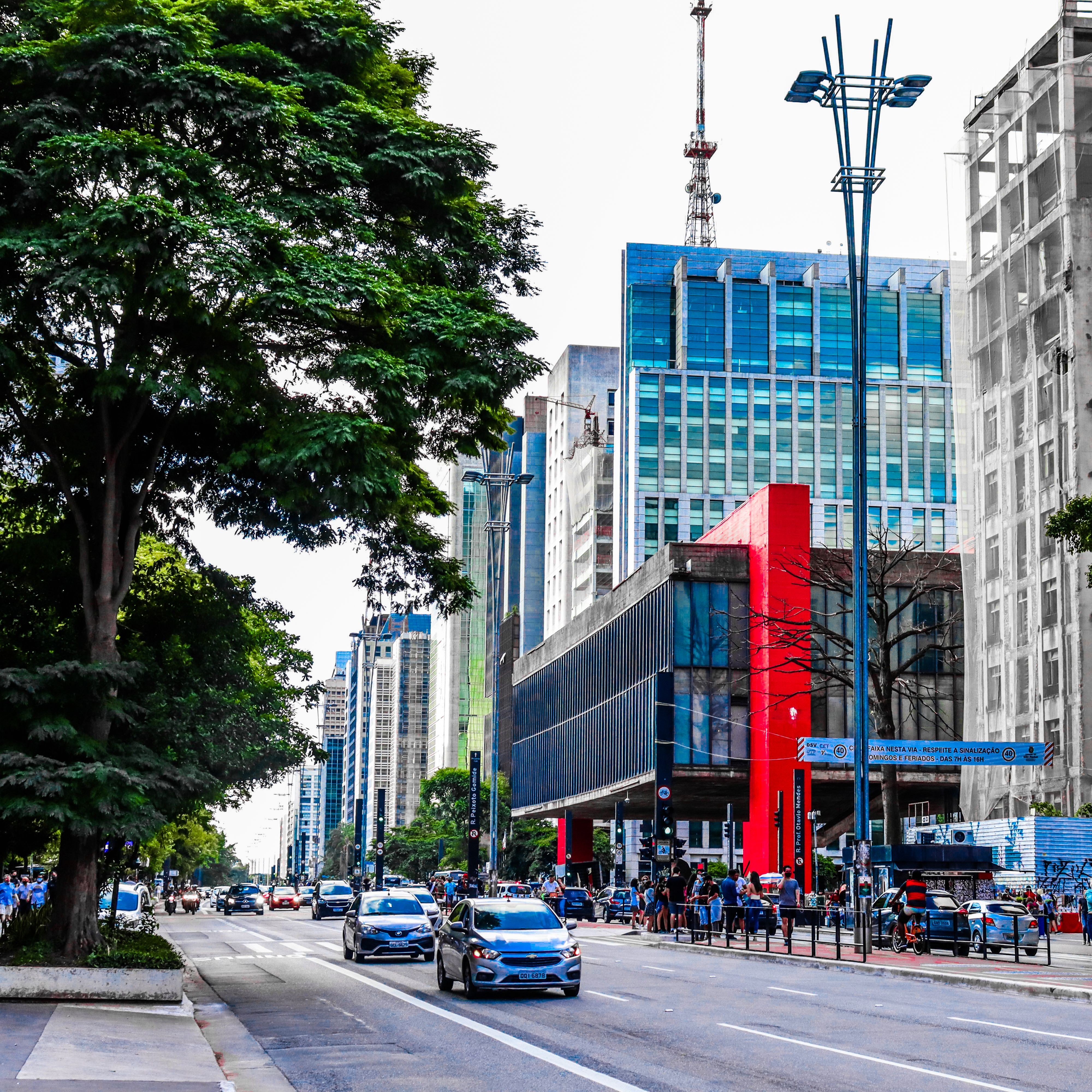 Parked Cars on the Street Between Concrete Buildings · Free Stock Photo