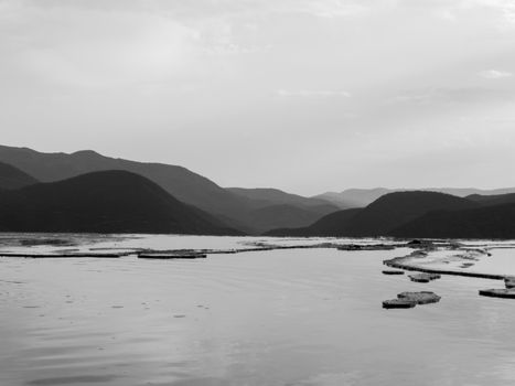 Peaceful monochrome view of a mountain range and lake, perfect for nature enthusiasts.