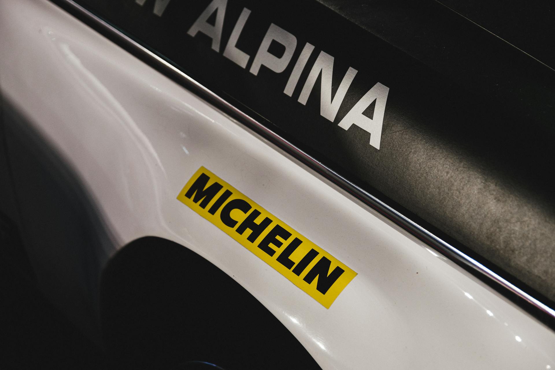 Detailed view of a Michelin sticker on a race car showcasing brand style.