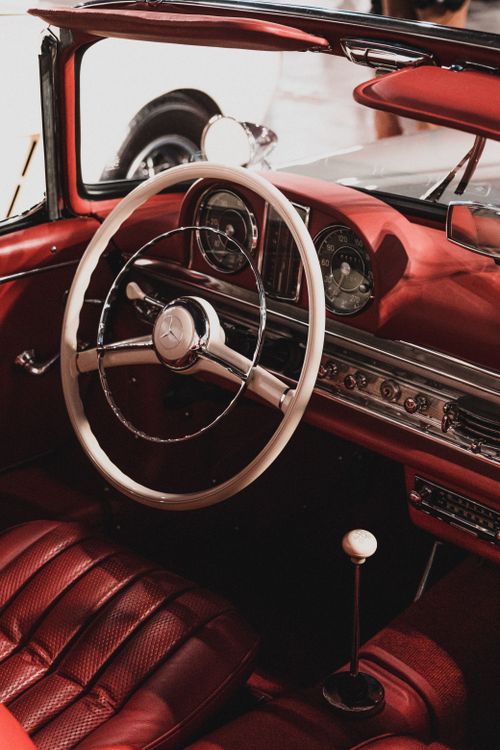 Free Close-up of a classic Mercedes Benz car interior showcasing the vintage steering wheel and dashboard. Stock Photo