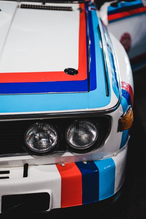 Free Detail view of a classic racing car featuring colorful stripes and headlight design. Stock Photo