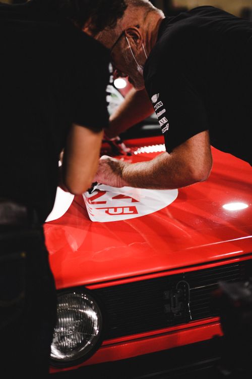 Man Putting Sticker Men Putting Stickers on a Car · Free Stock Photo