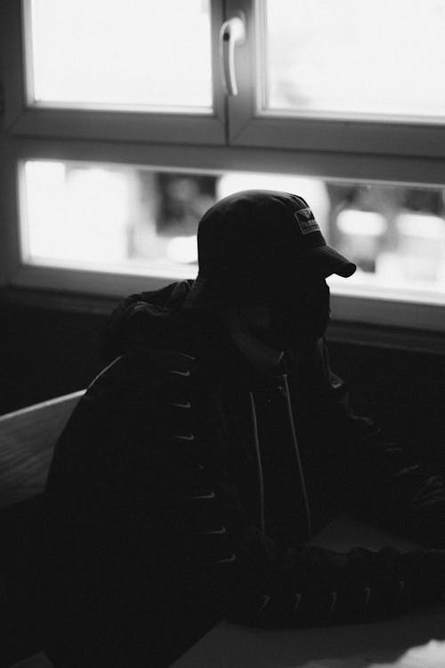 A Person Dressed in Black Sitting on a Chair