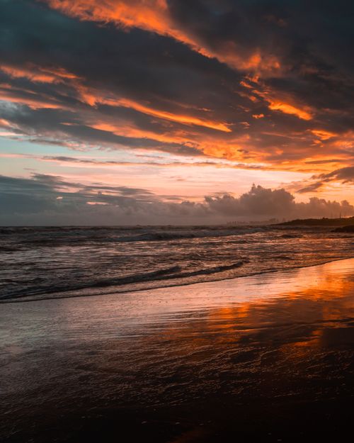 Free Vivid sunset colors reflecting over the ocean at Punta del Este beach, Uruguay. Stock Photo